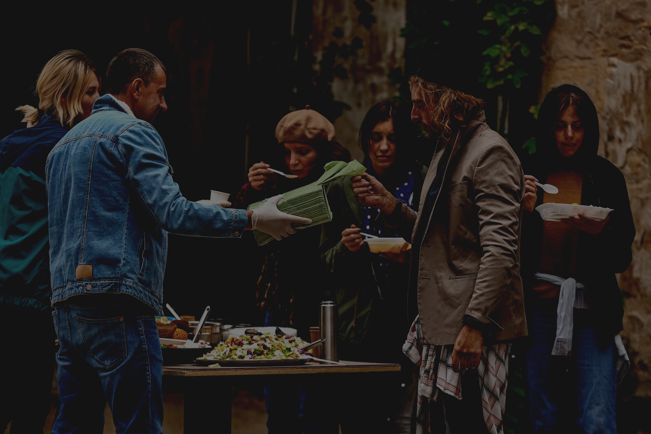 Volunteers Giving Food to Homeless People Outdoors